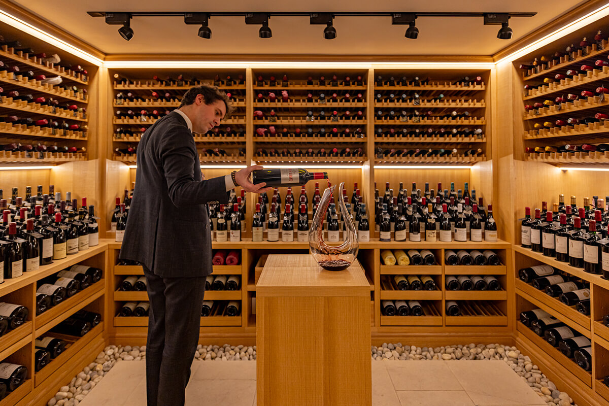 Sommelier pouring wine inside Claridge's Wine Cellar